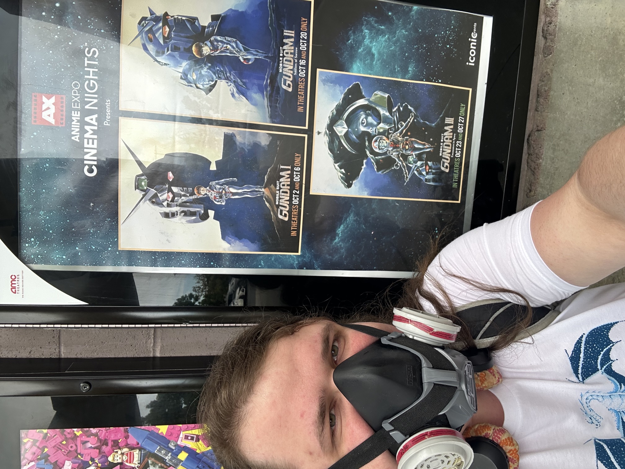 Me in a respirator standing in front of the Mobile Suit Gundam movie posters